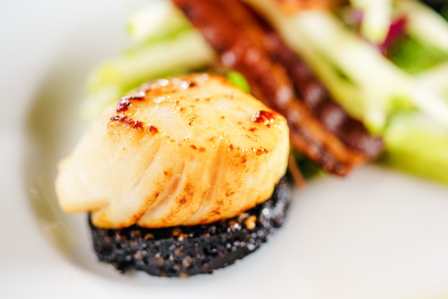 Perfectly seared scallop on a bed of black rice